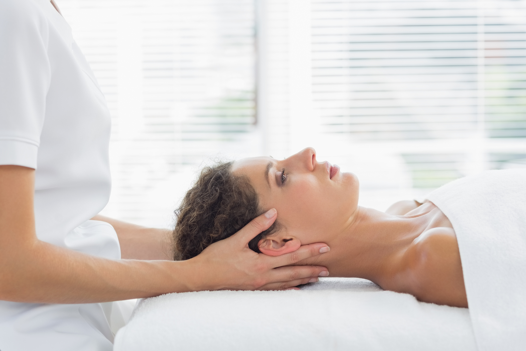 Side view of woman receiving body massage in health spa